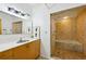 Bright bathroom featuring a vanity with sink and a glass-enclosed shower with a built-in tub at 195 Arizona Ne Ave # 104, Atlanta, GA 30307