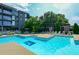 Community swimming pool with lounge chairs and lush landscaping on a sunny day at 195 Arizona Ne Ave # 104, Atlanta, GA 30307