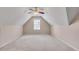 Large attic featuring carpet flooring and natural light from a window at 2417 Saint Feagin Pl, Powder Springs, GA 30127