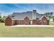 View of the brick exterior and patio, creating a seamless indoor-outdoor living experience at 2417 Saint Feagin Pl, Powder Springs, GA 30127