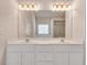 Bathroom featuring double vanity with white cabinets and a large mirror at 2417 Saint Feagin Pl, Powder Springs, GA 30127