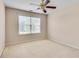 Cozy bedroom with neutral walls, carpet, ceiling fan, and natural light from a window at 2417 Saint Feagin Pl, Powder Springs, GA 30127