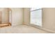 Bedroom features a large window and neutral carpet at 2417 Saint Feagin Pl, Powder Springs, GA 30127
