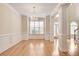 Formal dining room with hardwood floors, chandelier, and wainscoting at 2417 Saint Feagin Pl, Powder Springs, GA 30127