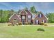 Beautiful two-story brick home with lush green lawn and mature landscaping, offering great curb appeal at 2417 Saint Feagin Pl, Powder Springs, GA 30127