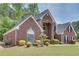 Charming red brick home with manicured front lawn and mature landscaping at 2417 Saint Feagin Pl, Powder Springs, GA 30127
