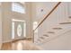 Two story foyer with hardwood floors and entry door with decorative glass at 2417 Saint Feagin Pl, Powder Springs, GA 30127