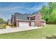 Spacious three-car garage on a well-maintained lawn surrounded by landscaping, providing ample parking at 2417 Saint Feagin Pl, Powder Springs, GA 30127