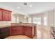 Kitchen has hardwood floors, stainless steel appliances, granite countertops and opens to the breakfast area at 2417 Saint Feagin Pl, Powder Springs, GA 30127