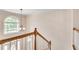 Bright staircase with wood handrail ascends to the upper level, bathed in natural light at 2417 Saint Feagin Pl, Powder Springs, GA 30127