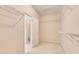 Spacious walk-in closet with open shelving and carpet flooring, providing ample storage space at 2417 Saint Feagin Pl, Powder Springs, GA 30127