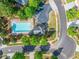 An aerial view of the community pool with a pool house, parking area, and landscaping at 525 Roland Manor Dr, Dacula, GA 30019