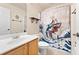 Bathroom with a fun decorative shower curtain, tile floors, and a wood vanity and mirror at 525 Roland Manor Dr, Dacula, GA 30019