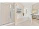 Bright bathroom featuring a shower, large tub, tile floors, and access to the main bedroom at 525 Roland Manor Dr, Dacula, GA 30019