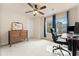 Bedroom with carpeted floors, ceiling fan, large window, and a wooden vanity and mirror at 525 Roland Manor Dr, Dacula, GA 30019