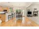 Inviting dining room open to the kitchen and living area, featuring wood floors and natural light at 525 Roland Manor Dr, Dacula, GA 30019