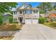 Two-story home with a two-car garage, brick accents, and a well-manicured lawn at 525 Roland Manor Dr, Dacula, GA 30019