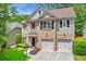 Charming two-story home featuring a brick facade, two-car garage, and beautifully landscaped front yard at 525 Roland Manor Dr, Dacula, GA 30019