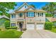 Charming two-story home with a brick and siding exterior, complemented by a well-manicured lawn and a two car garage at 525 Roland Manor Dr, Dacula, GA 30019