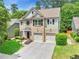 Charming two-story home with a brick facade, two-car garage, and well-maintained landscaping at 525 Roland Manor Dr, Dacula, GA 30019