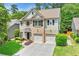 Charming two-story home featuring a brick facade, two-car garage, and beautifully landscaped front yard at 525 Roland Manor Dr, Dacula, GA 30019