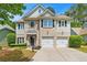 Beautiful two-story home featuring brick and siding exterior, attached two car garage, and manicured front yard at 525 Roland Manor Dr, Dacula, GA 30019