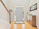 Bright foyer with hardwood floors, a staircase, and natural light streaming through the window at 525 Roland Manor Dr, Dacula, GA 30019