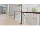 Open hallway featuring dark wood and white railings, carpeted floors, and lots of natural light at 525 Roland Manor Dr, Dacula, GA 30019