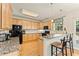 Well-lit kitchen featuring granite countertops, stainless steel appliances, breakfast bar with pendant lights, and hardwood floors at 525 Roland Manor Dr, Dacula, GA 30019