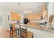 Well-lit kitchen boasts granite countertops, breakfast bar, and modern appliances at 525 Roland Manor Dr, Dacula, GA 30019