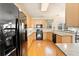 Bright kitchen featuring wood floors, ample counter space, and modern appliances at 525 Roland Manor Dr, Dacula, GA 30019