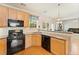 Well-appointed kitchen with wood cabinets, stainless steel appliances, and granite counters at 525 Roland Manor Dr, Dacula, GA 30019