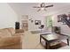 Spacious living room with neutral carpet, tan couches, and a ceiling fan at 525 Roland Manor Dr, Dacula, GA 30019