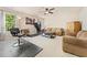 Bright living room featuring a seating area, workout equipment, and neutral-toned decor at 525 Roland Manor Dr, Dacula, GA 30019