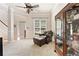 Cozy living room featuring a leather chair and ottoman, carpet, and a display cabinet at 525 Roland Manor Dr, Dacula, GA 30019