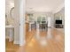 Open-concept living space with hardwood flooring, kitchen with breakfast bar, and a dining area with patio access at 525 Roland Manor Dr, Dacula, GA 30019