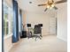 Office with carpeted floors, a ceiling fan, large window, and a modern desk and chair at 525 Roland Manor Dr, Dacula, GA 30019