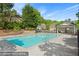 Community pool area with a pool house, chairs, and a fenced-in area at 525 Roland Manor Dr, Dacula, GA 30019
