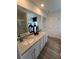 Bathroom with granite countertops, double sinks, a large mirror and tile floors at 1569 Aiden Way # 35, Conyers, GA 30013