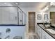 Bright bathroom features a double vanity, glass enclosed shower and entry to walk-in closet at 1569 Aiden Way # 35, Conyers, GA 30013
