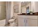 Bathroom featuring a toilet, shower, and white vanity with a dark countertop at 1569 Aiden Way # 35, Conyers, GA 30013