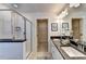 Bright bathroom with double vanity, glass shower, and walk in closet at 1569 Aiden Way # 35, Conyers, GA 30013
