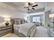 Spacious bedroom with tray ceilings, ceiling fan and sitting area at 1569 Aiden Way # 35, Conyers, GA 30013
