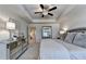 Bedroom featuring a soft color palette, ceiling fan, and mirrored dresser at 1569 Aiden Way # 35, Conyers, GA 30013