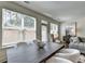 Bright dining room features a large window, dark wood table, and opens to the living room at 1569 Aiden Way # 35, Conyers, GA 30013