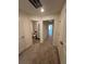 Hallway leading to a bathroom, featuring neutral carpet and white doors, and access to another room at 1569 Aiden Way # 35, Conyers, GA 30013