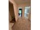 Hallway view with bedrooms visible through doors, featuring neutral carpet flooring and a storage closet at 1569 Aiden Way # 35, Conyers, GA 30013