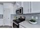 Modern kitchen with stainless steel appliances, quartz countertops, and subway tile backsplash at 1569 Aiden Way # 35, Conyers, GA 30013