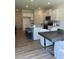 Spacious kitchen featuring modern appliances, an island with seating, and an open layout to dining area at 1569 Aiden Way # 35, Conyers, GA 30013