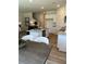 Open concept kitchen with an island, stainless steel appliances, and a view of the living room and staircase at 1569 Aiden Way # 35, Conyers, GA 30013